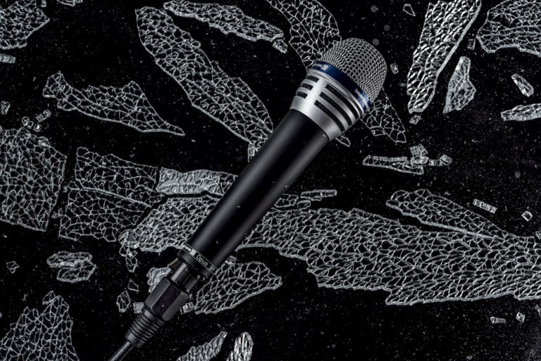Glass shattering special effect advertising image of a microphone