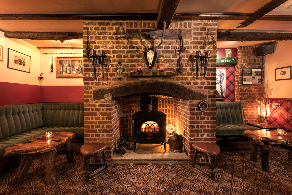 Showing the feel of a space - warm cosy pub interior with fireplace