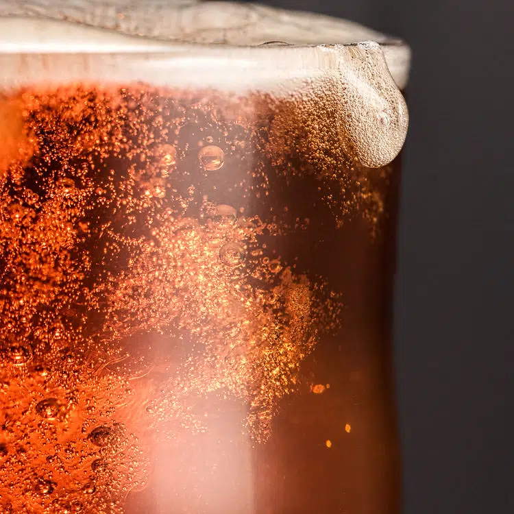 Close up of beer in pint glass with drop over the rim