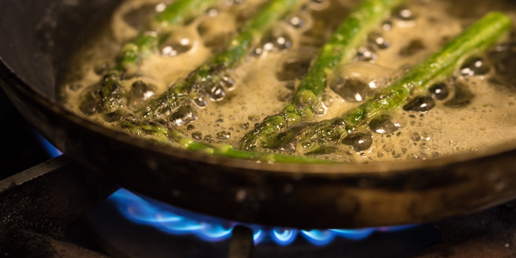 Asparagus frying in butter