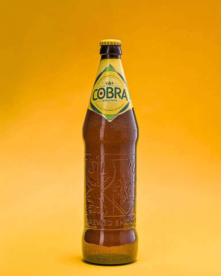 Bottle of Cobra Beer on Yellow Background