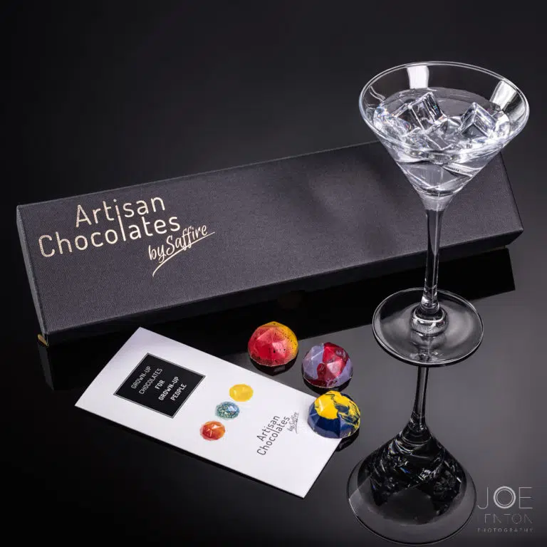 Box of luxury chocolates with drink in cocktail glass