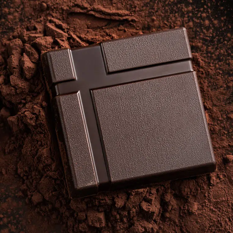Creative Chocolate Photography - square dark chocolate on cocoa powder