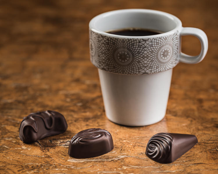 Chocolates with cup of coffee