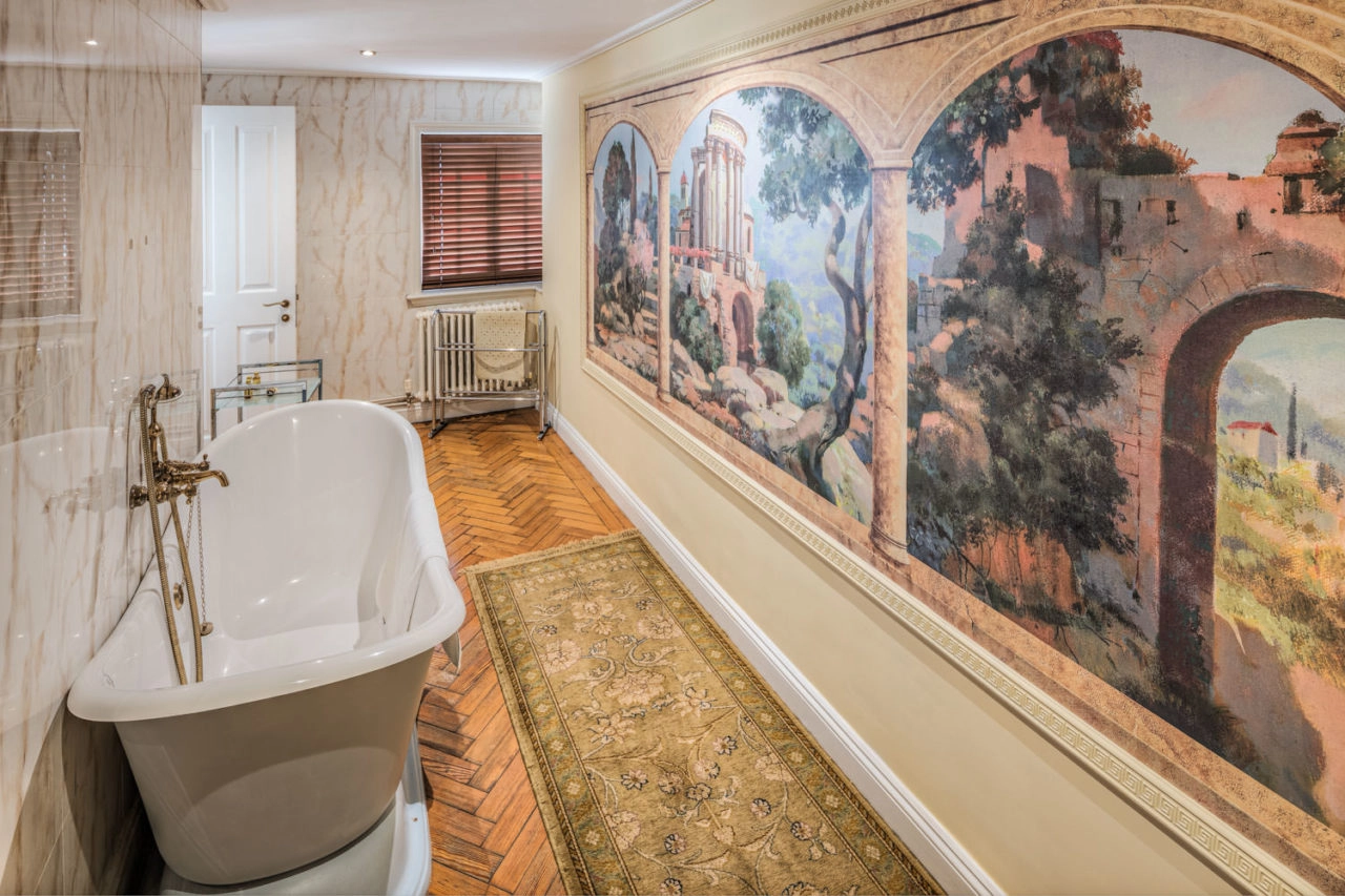 Luxury hotel bathroom with mural painted on wall