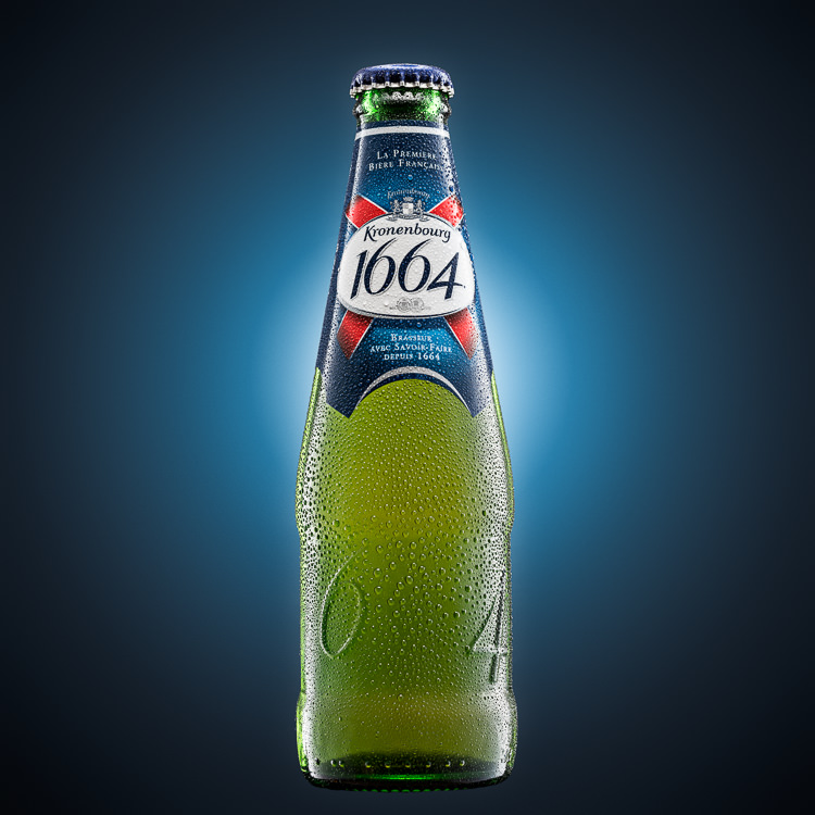Kronenbourg Beer Bottle Advertising Photo on blue background glow