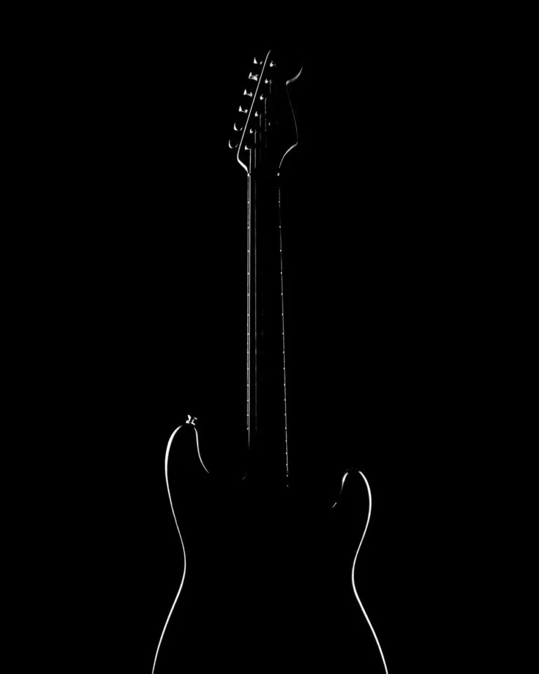 Fender Stratocaster guitar silhouette lit only around the edge