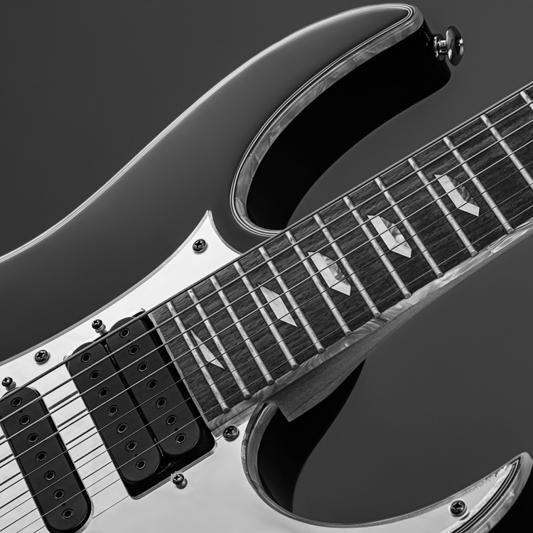 Close up guitar photography of Ibanez Universe neck end of body in monochrome